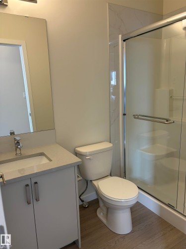 Bathroom featuring vanity, a shower stall, and wood finished floors - 5756 Hawthorn Common, Edmonton, AB - Indoor Photo Showing Bathroom
