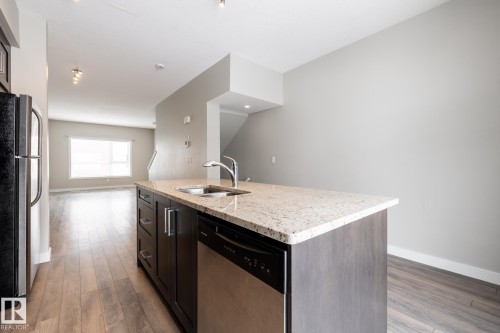 127 2560 Pegasus Boulevard, Edmonton, AB - Indoor Photo Showing Kitchen With Double Sink
