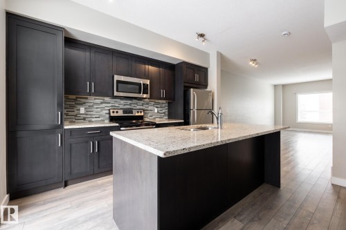 127 2560 Pegasus Boulevard, Edmonton, AB - Indoor Photo Showing Kitchen With Stainless Steel Kitchen With Upgraded Kitchen