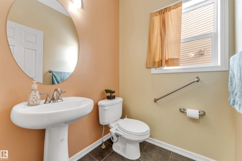 Bathroom featuring toilet and dark tile patterned flooring - 3449 28 Street, Edmonton, AB - Indoor Photo Showing Bathroom