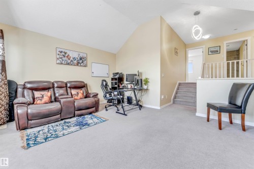 Living area featuring light colored carpet, lofted ceiling, and an office area - 3449 28 Street, Edmonton, AB - Indoor Photo Showing Other Room