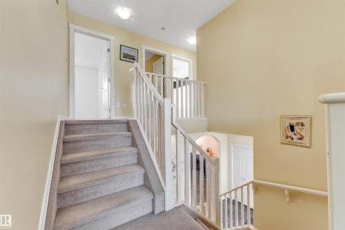 Stairway with carpet flooring and baseboards - 3449 28 Street, Edmonton, AB - Indoor Photo Showing Other Room