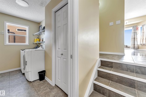 Laundry room featuring a textured ceiling and separate washer and dryer - 3449 28 Street, Edmonton, AB - Indoor Photo Showing Laundry Room