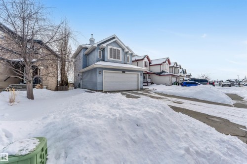 Traditional home with a chimney, a residential view, and a garage - 3449 28 Street, Edmonton, AB - Outdoor