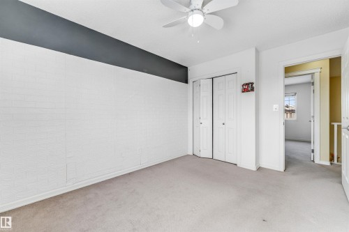 Unfurnished bedroom featuring light carpet, a closet, and ceiling fan - 3449 28 Street, Edmonton, AB - Indoor Photo Showing Other Room