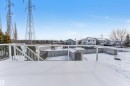 Yard covered in snow with a residential view, a deck, a storage unit, and a fenced backyard - 3449 28 Street, Edmonton, AB  - Outdoor 