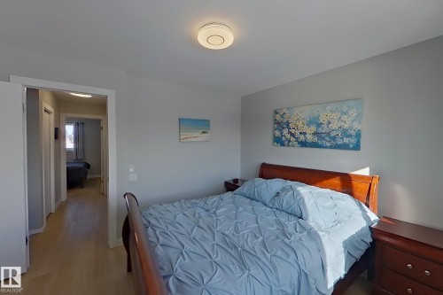 Bedroom with wood finished floors - 121 1 Aberdeen Way, Stony Plain, AB - Indoor Photo Showing Bedroom