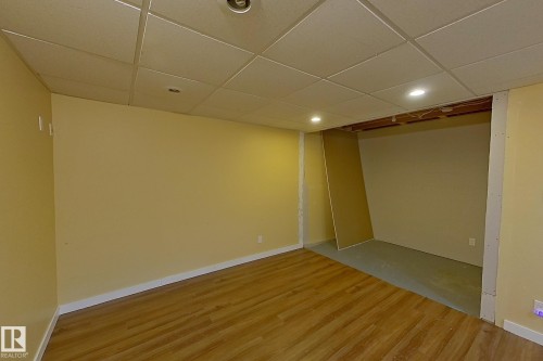 Finished basement featuring a paneled ceiling, recessed lighting, and light wood-style floors - 121 1 Aberdeen Way, Stony Plain, AB - Indoor