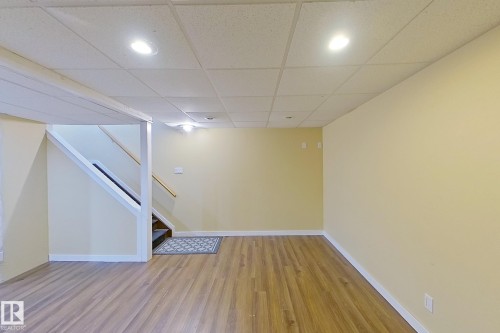 Finished below grade area featuring light wood-style floors and a paneled ceiling - 121 1 Aberdeen Way, Stony Plain, AB - Indoor Photo Showing Other Room