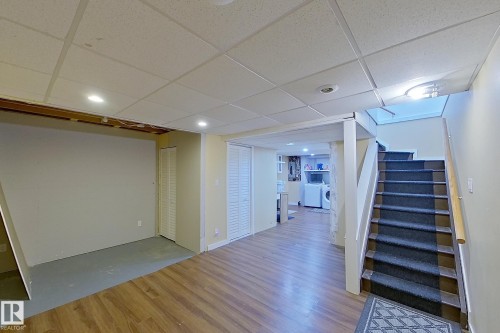 Finished basement with a paneled ceiling, recessed lighting, light wood finished floors, and washing machine and dryer - 121 1 Aberdeen Way, Stony Plain, AB - Indoor