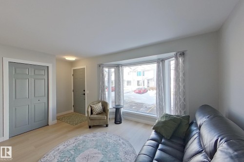 Living room featuring light wood-style flooring and baseboards - 121 1 Aberdeen Way, Stony Plain, AB - Indoor Photo Showing Living Room