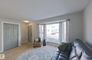 Living room featuring light wood-style flooring and baseboards - 121 1 Aberdeen Way, Stony Plain, AB  - Indoor Photo Showing Living Room 