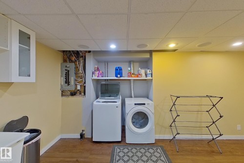 Laundry room with a drop ceiling, electric panel, washer and dryer, light wood-type flooring, and recessed lighting - 121 1 Aberdeen Way, Stony Plain, AB - Indoor Photo Showing Laundry Room