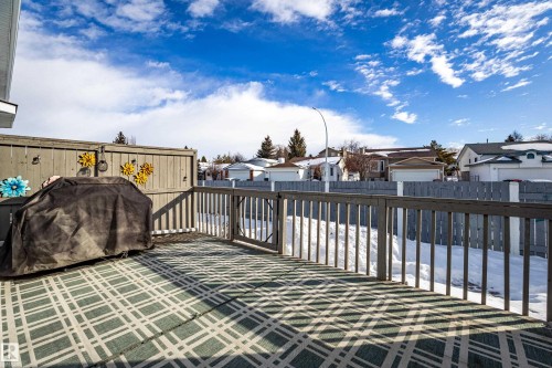Wooden deck with a residential view, a fenced backyard, and grilling area - 121 1 Aberdeen Way, Stony Plain, AB - Outdoor