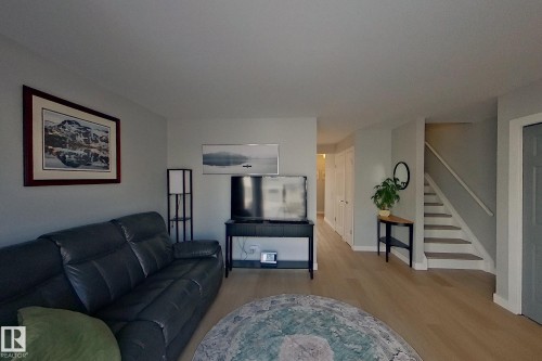 Living area featuring stairway and light wood-type flooring - 121 1 Aberdeen Way, Stony Plain, AB - Indoor Photo Showing Living Room