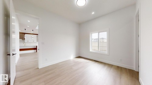Empty room with light wood-type flooring and recessed lighting - 1707 18 Street, Edmonton, AB - Indoor Photo Showing Other Room