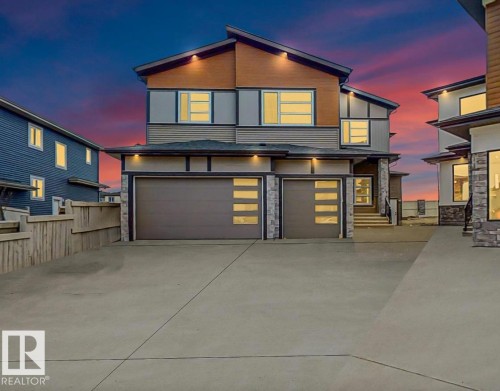 Contemporary home featuring stone siding, a garage, and driveway - 1707 18 Street, Edmonton, AB - Outdoor