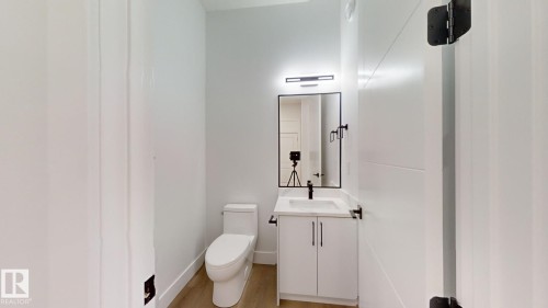 Bathroom with vanity and light wood-style flooring - 1707 18 Street, Edmonton, AB - Indoor Photo Showing Bathroom