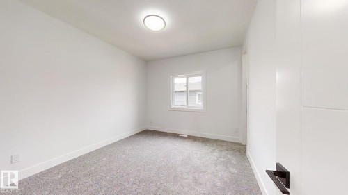 Empty room with light carpet and baseboards - 1707 18 Street, Edmonton, AB - Indoor Photo Showing Other Room