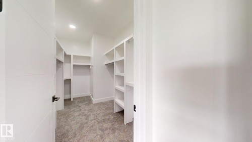 Walk in closet featuring light colored carpet - 1707 18 Street, Edmonton, AB - Indoor