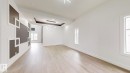 Empty room featuring a tray ceiling and light wood finished floors - 1707 18 Street, Edmonton, AB  - Indoor Photo Showing Other Room 