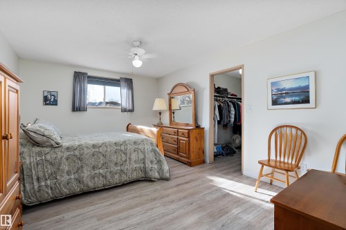 Bedroom featuring a spacious closet, light wood-type flooring, and ceiling fan - 116 11620 9A Avenue, Edmonton, AB - Indoor Photo Showing Bedroom