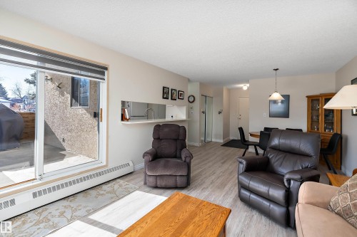 Living room featuring light flooring and sliding patio doors - 116 11620 9A Avenue, Edmonton, AB - Indoor Photo Showing Living Room