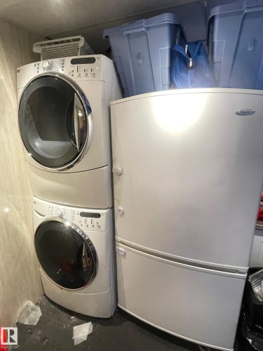 Laundry area with stacked washer / dryer - 324 Warwick Road, Edmonton, AB - Indoor Photo Showing Laundry Room