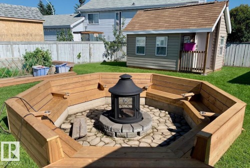 Huge 18' 20' Wooden terrace with a fenced backyard and a Sun-kin fire pit. Check out this "REAL" She-Shed that’s  insulated, heated with power and internet fantastic for any hobbiest. - 324 Warwick Road, Edmonton, AB - Outdoor With Deck Patio Veranda