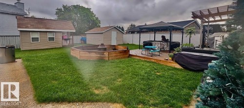 Fenced backyard with a deck, a storage unit, and a fire pit - 324 Warwick Road, Edmonton, AB - Outdoor