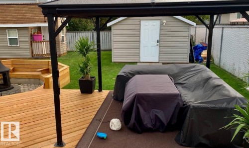 Wooden deck featuring a fenced backyard, a storage unit, grilling area, a gazebo, and a patio area - 324 Warwick Road, Edmonton, AB - Outdoor With Deck Patio Veranda With Exterior
