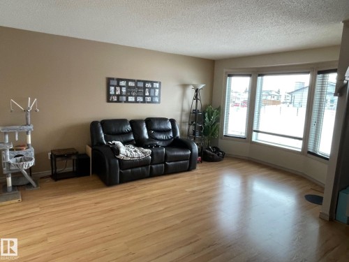 Living room with light wood finished floors and a textured ceiling - 324 Warwick Road, Edmonton, AB - Indoor Photo Showing Living Room