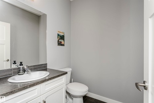 Half bathroom featuring vanity and toilet - 16420 15 Avenue, Edmonton, AB - Indoor Photo Showing Bathroom