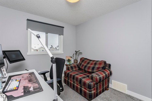 Office area featuring carpet and a textured ceiling - 16420 15 Avenue, Edmonton, AB - Indoor