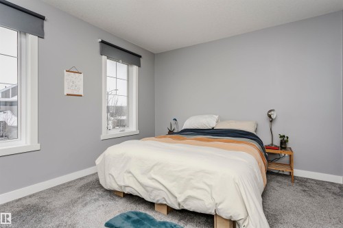 Carpeted bedroom with baseboards - 16420 15 Avenue, Edmonton, AB - Indoor Photo Showing Bedroom