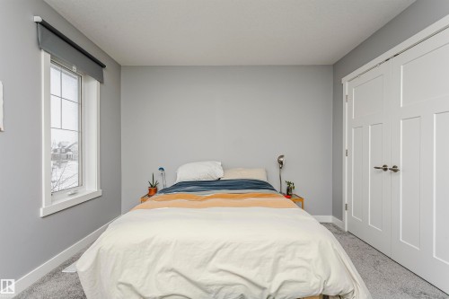 Bedroom featuring light carpet and a closet - 16420 15 Avenue, Edmonton, AB - Indoor Photo Showing Bedroom