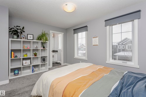 Bedroom with carpet flooring and a textured ceiling - 16420 15 Avenue, Edmonton, AB - Indoor Photo Showing Bedroom