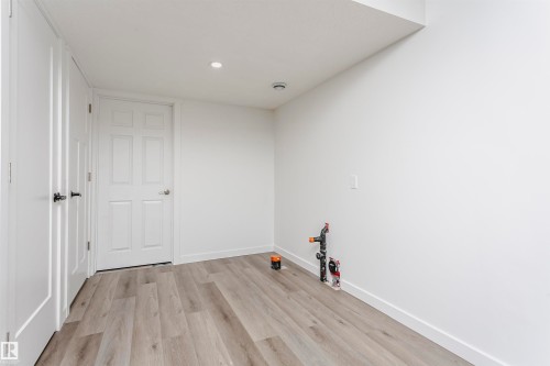 Spare room with light wood finished floors and recessed lighting - 16420 15 Avenue, Edmonton, AB - Indoor Photo Showing Other Room