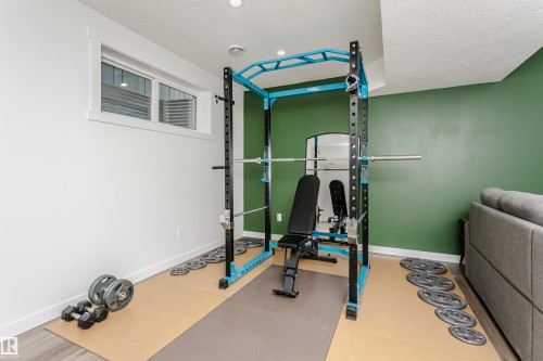 Workout room with a textured ceiling - 16420 15 Avenue, Edmonton, AB - Indoor Photo Showing Gym Room