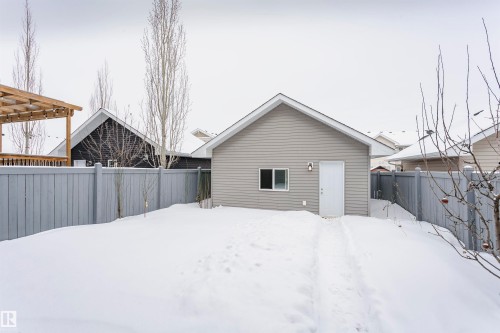 Snow covered rear of property with a fenced backyard - 16420 15 Avenue, Edmonton, AB - Outdoor