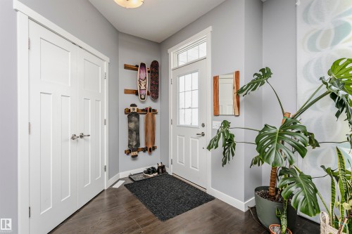 Foyer with dark wood-style floors and baseboards - 16420 15 Avenue, Edmonton, AB - Indoor Photo Showing Other Room