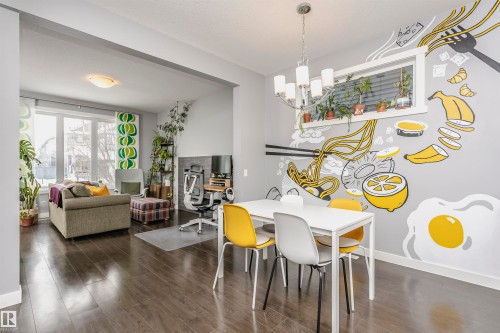 Dining space with dark wood-type flooring and a chandelier - 16420 15 Avenue, Edmonton, AB - Indoor