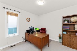 Office with light colored carpet and a textured ceiling - 