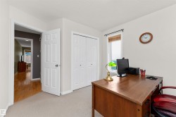 Office with light colored carpet and a textured ceiling - 