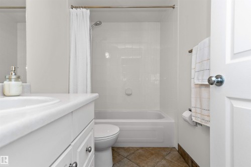 Bathroom featuring vanity, shower / tub combo, and light tile patterned floors - 357 Blackburn Drive E, Edmonton, AB - Indoor Photo Showing Bathroom