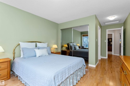 Bedroom with light wood-type flooring, a closet, and a textured ceiling - 357 Blackburn Drive E, Edmonton, AB - Indoor Photo Showing Bedroom
