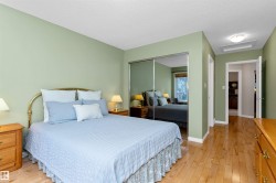 Bedroom with light wood-type flooring, a closet, and a textured ceiling - 