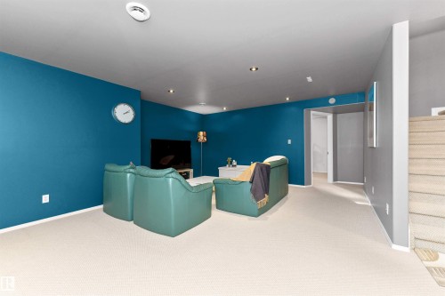 Home theater with light colored carpet and baseboards - 357 Blackburn Drive E, Edmonton, AB - Indoor Photo Showing Other Room