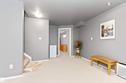 Living area featuring light carpet and baseboards - 