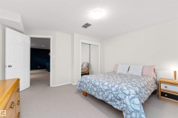 Bedroom with light colored carpet, a closet, and a textured ceiling - 